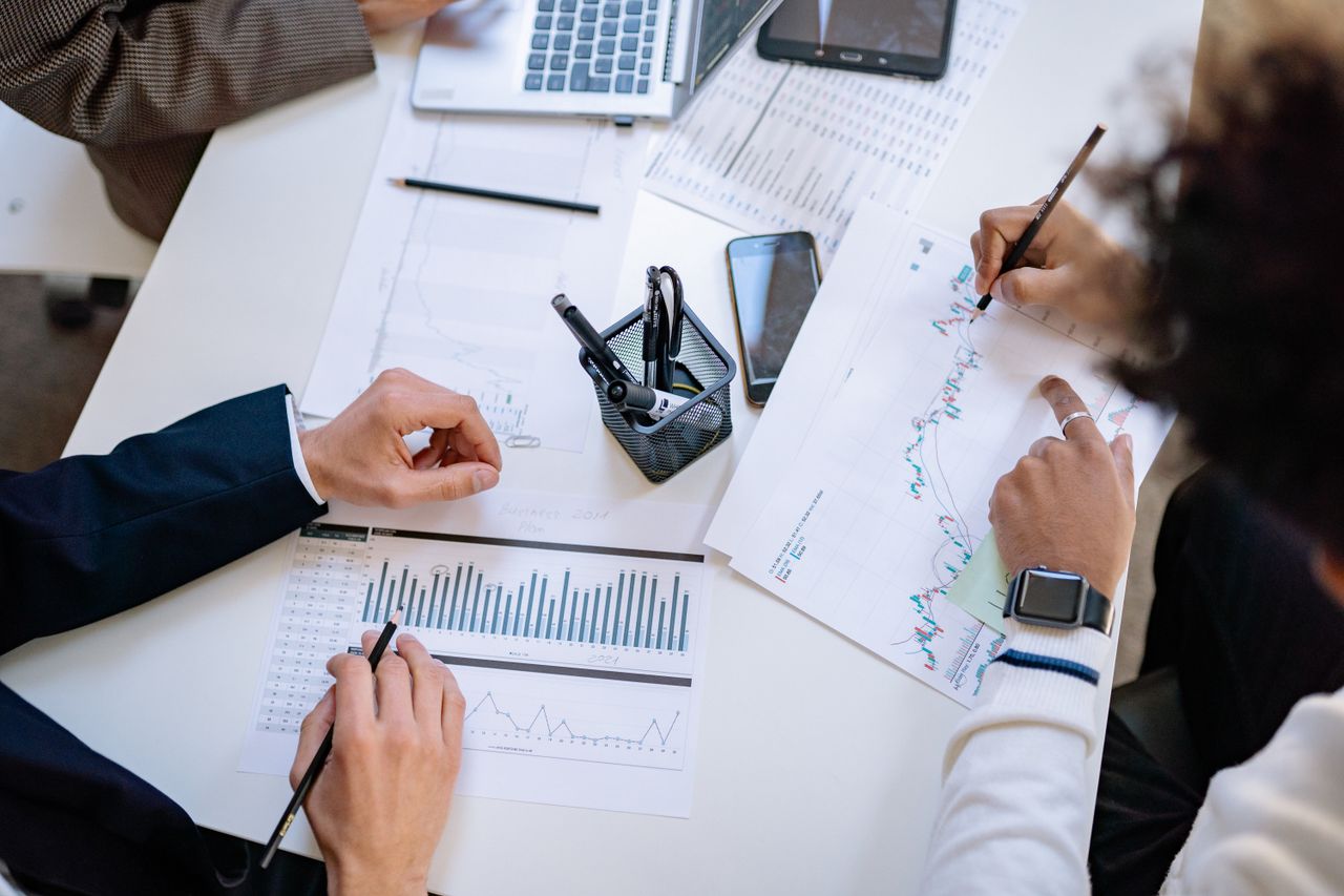 get-in-touch Business team analyzing financial charts and graphs during a collaborative meeting.